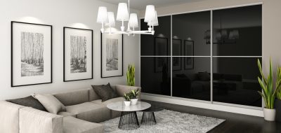 Sliding black fitted storage in a living room from the Vetrino range